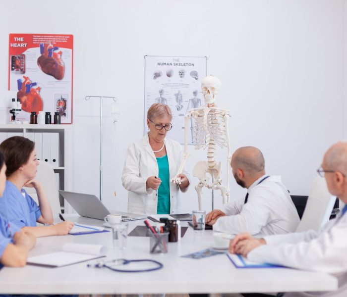 physician senior woman holding bone structure disc 2025 02 19 08 53 18 utc scaled
